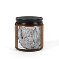 Candle jar with black lid and tree ring design on a white background